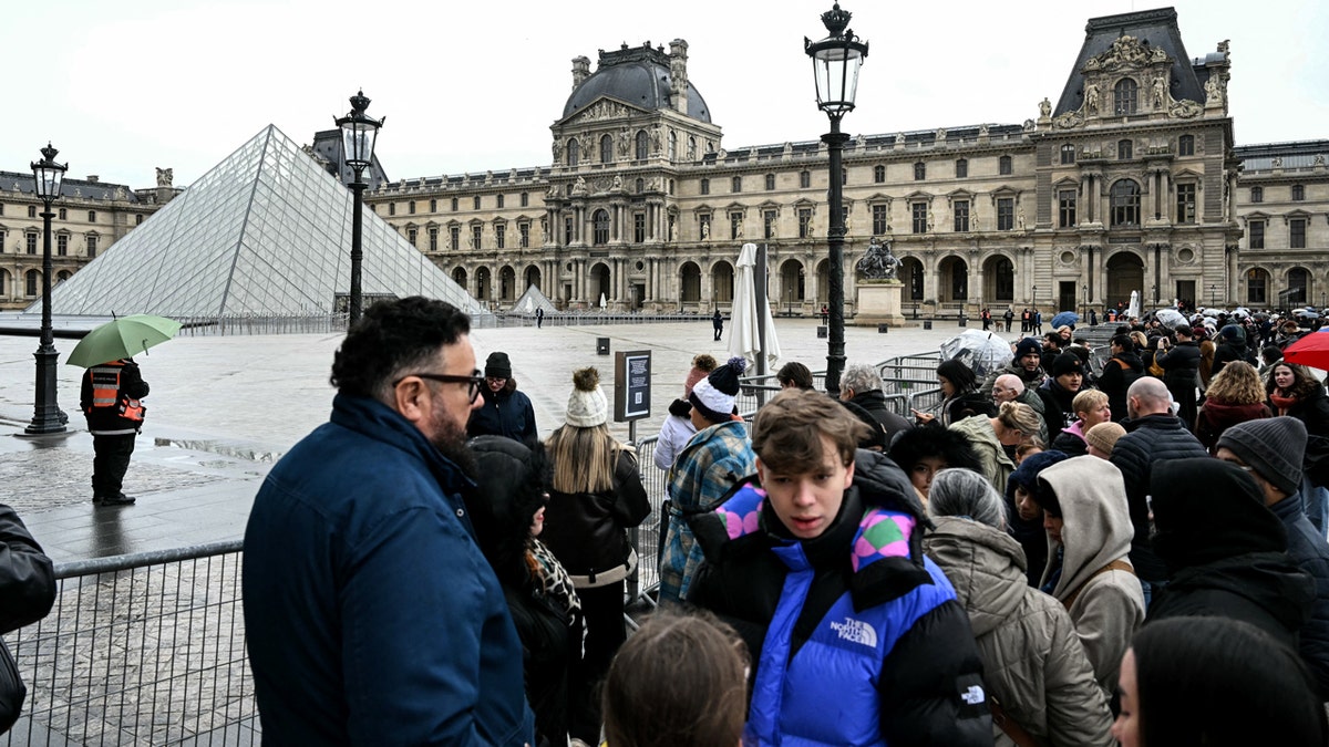 tourists waiting outside louvre during employee strike 