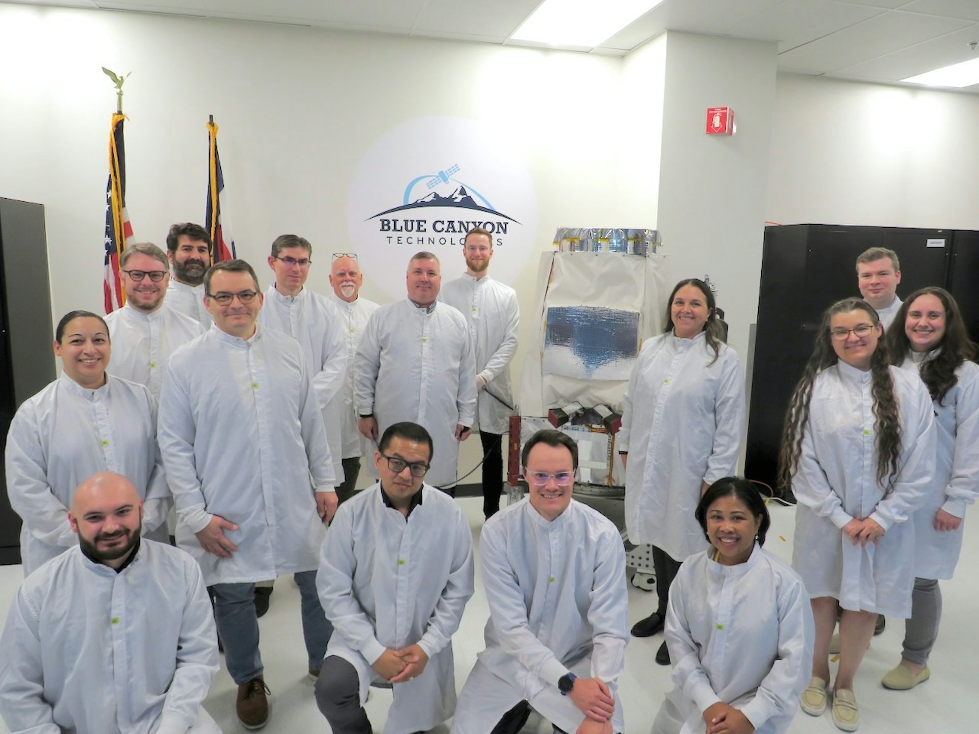 Members of the Pandora SmallSat team with the completed satellite in Blue Canyon Technologies&rsquo; cleanroom in Boulder, Colorado.