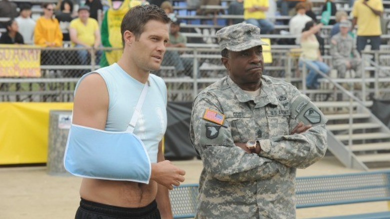 Staff Sergeant Pete Hill (Geoff Stults) and Command Sergeant Major Donald Cody (Keith David) observe an event in Enlisted