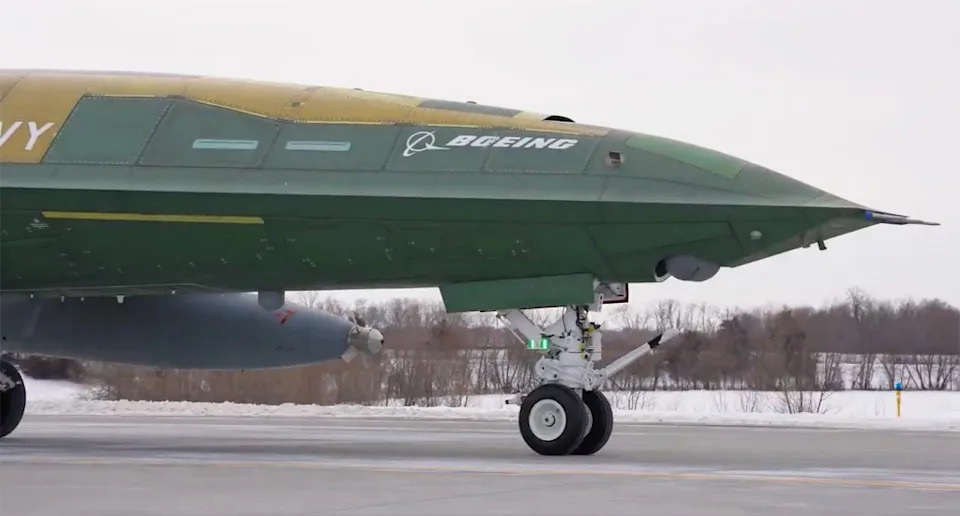 A look at the retracted sensor turret on the production-representative MQ-25. A buddy refueling store, which is how the drone will perform its primary tanking mission, is also seen here under the drone’s left wing. <em>Boeing capture</em>