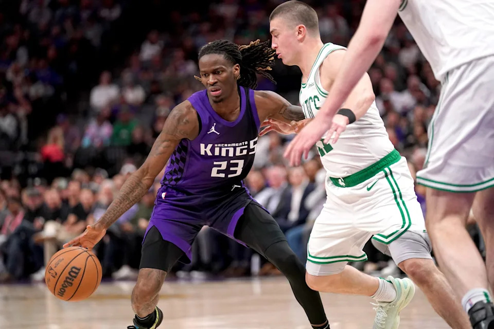 Mar 24, 2025; Sacramento, California, USA; Sacramento Kings guard Keon Ellis (23) dribbles the ball next to Boston Celtics guard Payton Pritchard (11) in the fourth quarter at the Golden 1 Center. Mandatory Credit: Cary Edmondson-Imagn Images