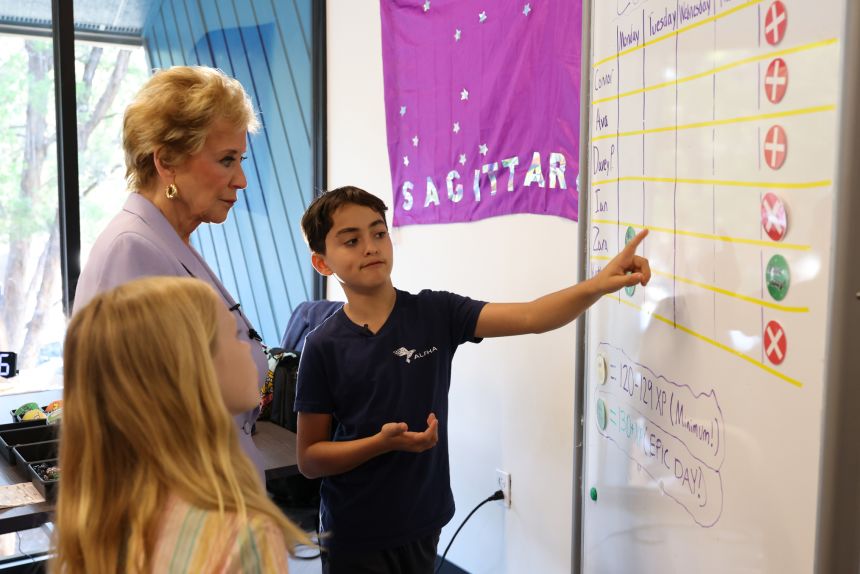Everest Nevraumont, US Secretary of Education Linda McMahon, and Jaxon Siers at Alpha School Austin on September 9, 2025 in Austin, Texas.