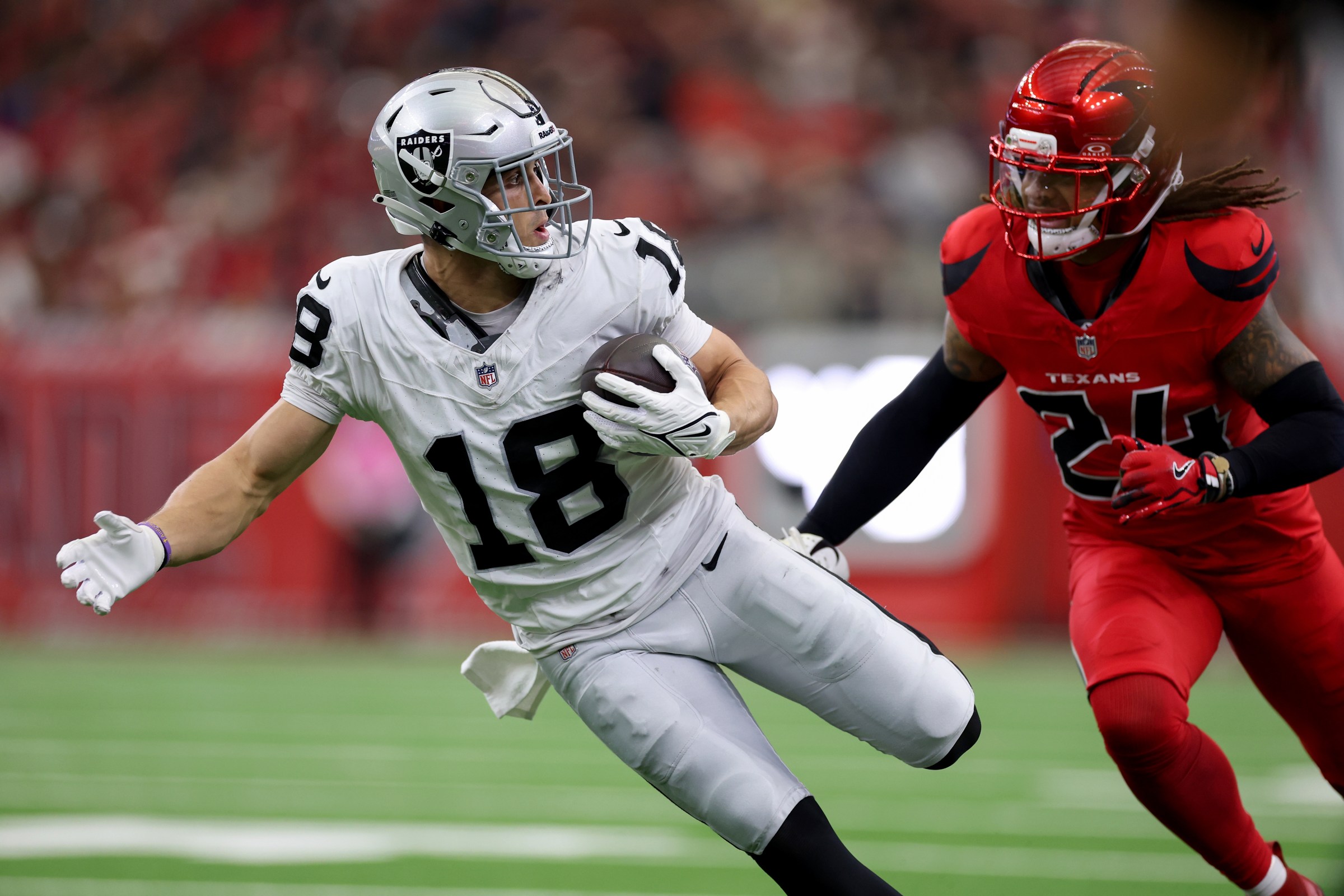 HOUSTON, TEXAS - DECEMBER 21: Jack Bech #18 of the Las Vegas Raiders runs after a reception in the first half against Derek Stingley Jr. #24 of the Houston Texans at NRG Stadium on December 21, 2025 in Houston, Texas. (Photo by Tim Warner/Getty Images)