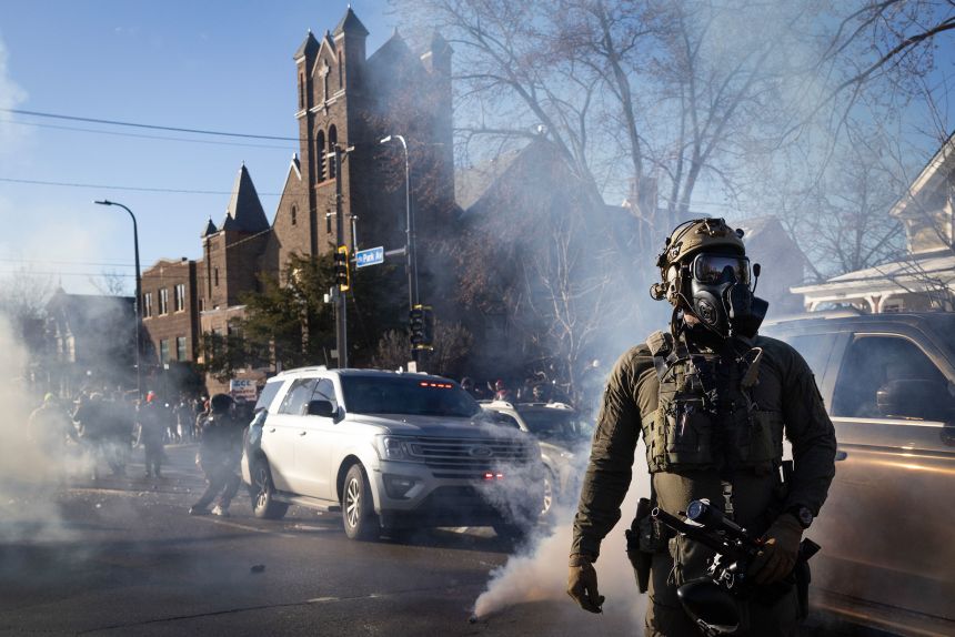 Tear gas fills the air as federal immigration agents clash with residents following a house raid in Minneapolis, Minnesota, on Tuesday.