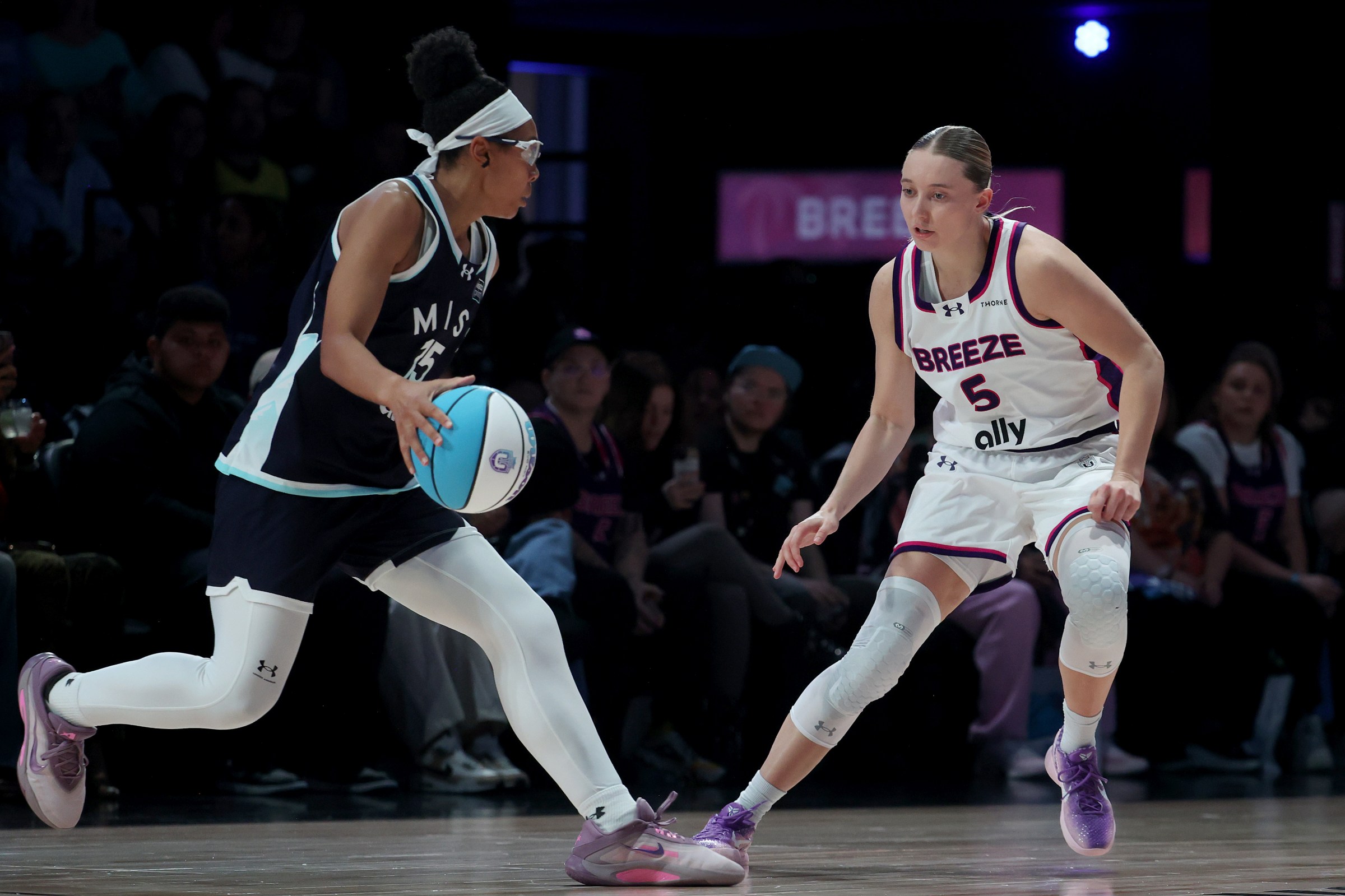 Mist’s Allisha Gray is defended by Breeze’s Paige Bueckers.