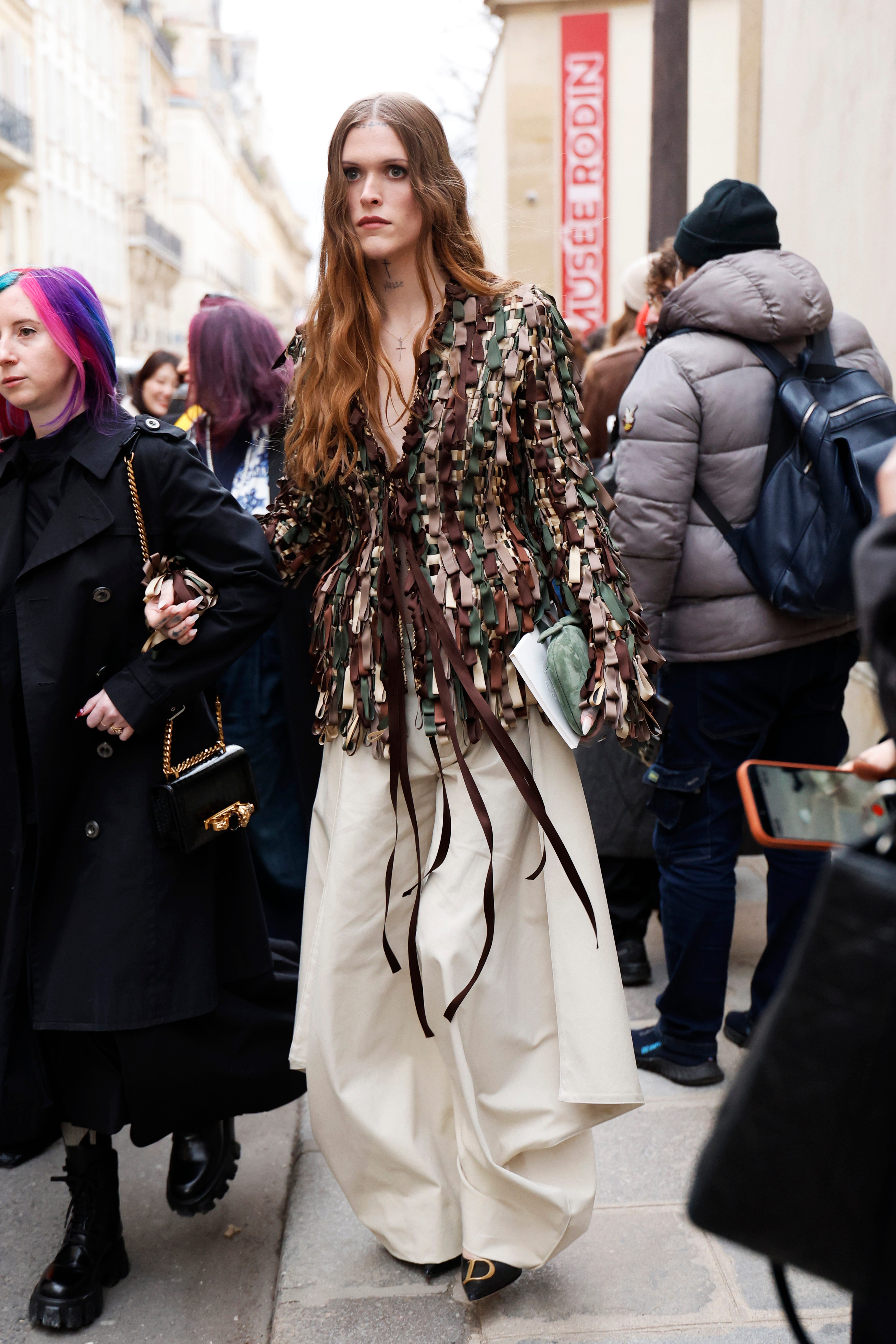 paris, france january 26: ethel cain wears intricate, green, brown, and beige multi colored woven jacket, oversized cream wide leg trousers, sage green suede clutch, outside christian dior, during the haute couture spring summer 2026 as part of paris fashion week on january 26, 2026 in paris, france. (photo by claudio lavenia/getty images)
