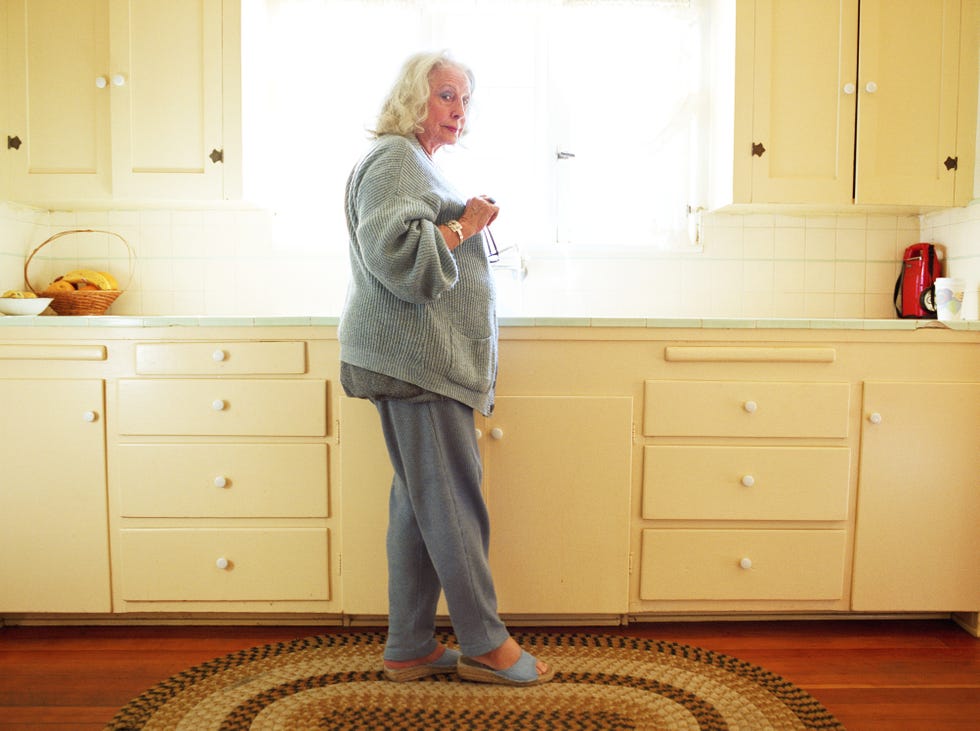 person standing in a kitchen near a window
