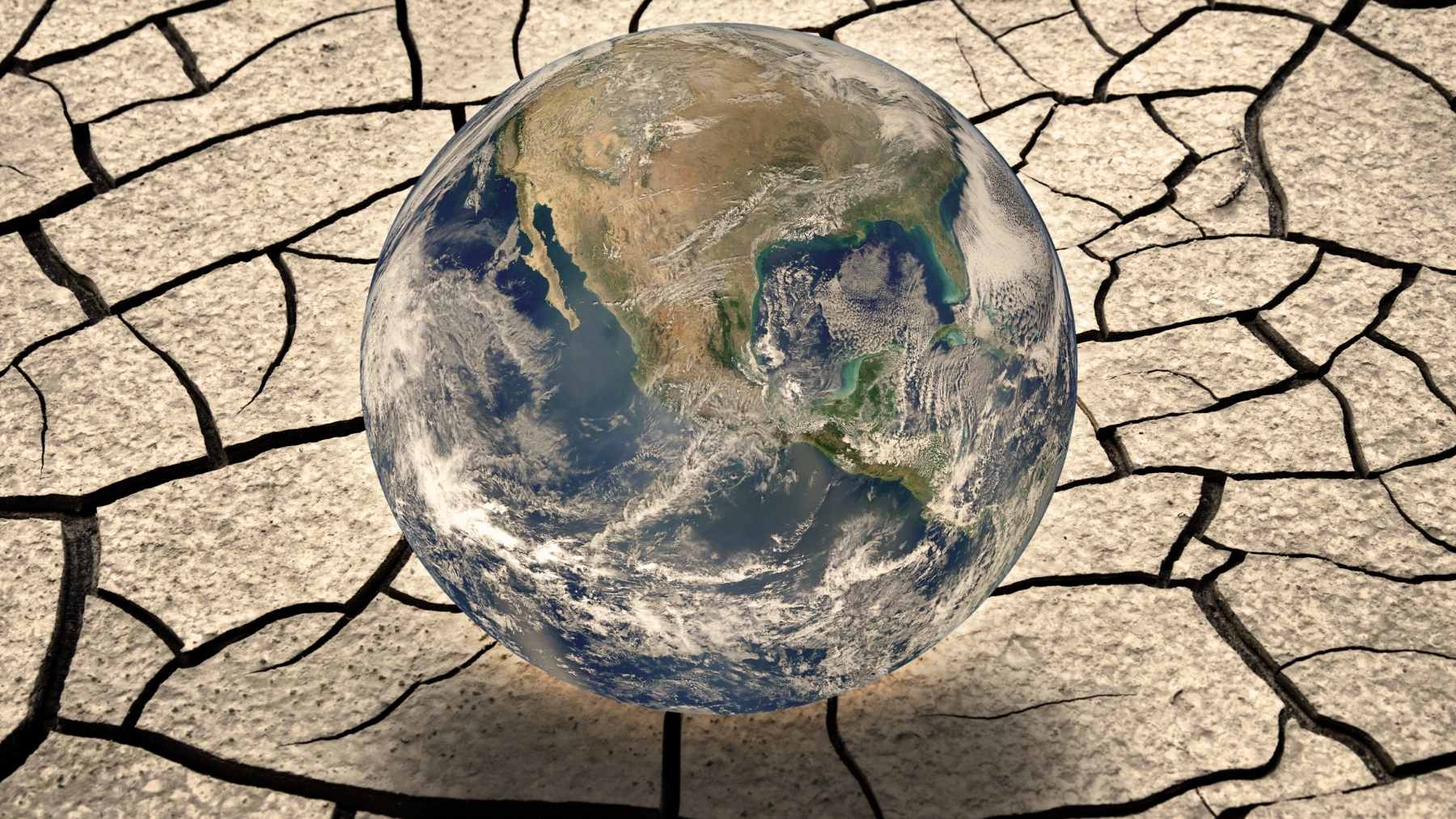 Earth over cracked dry ground symbolizing global water scarcity and “Day Zero” drought risk