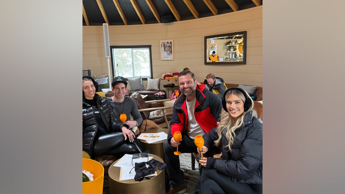 Christina Haack, Chris Larocca, Tarek El Moussa and Heather Rae El Moussa hold champagne glasses while spending time together during a blended-family getaway in Park City, Utah.