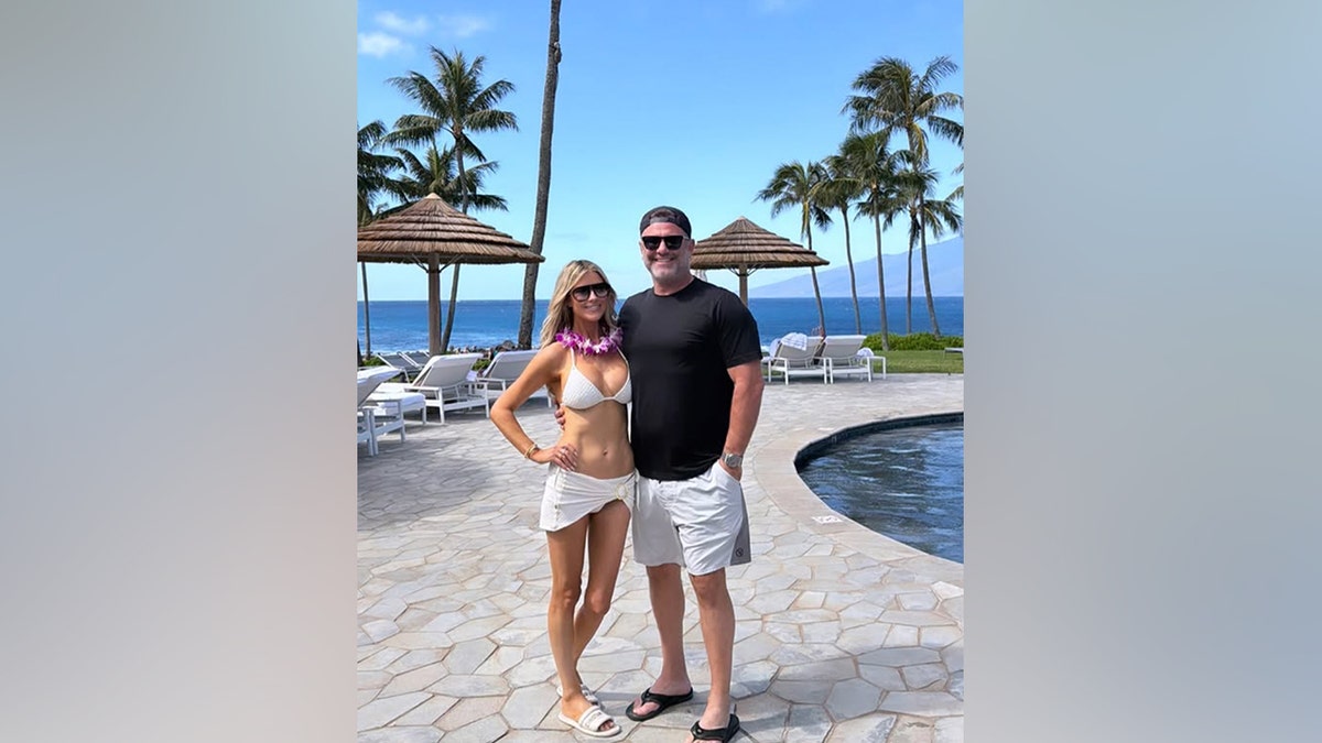 Christina Haack and Chris Larocca smile for a photo together at a resort.