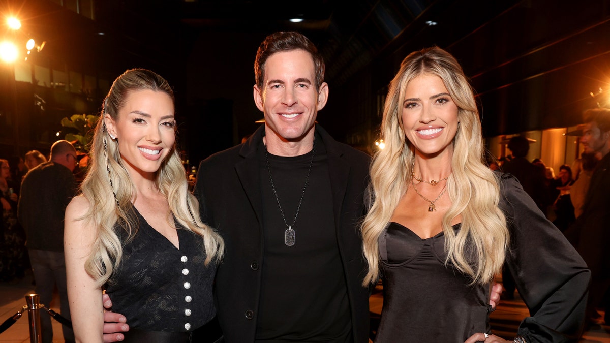 Heather Rae, Tarek El Moussa and Christina Haack all pose together wearing black