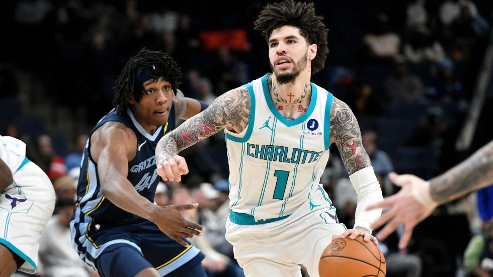Charlotte Hornets guard LaMelo Ball (1) handles the ball ahead of Memphis Grizzlies forward GG Jackson II in the first half of an NBA basketball game, Wednesday, Jan. 28, 2026, in Memphis, Tenn. (AP Photo/Brandon Dill)