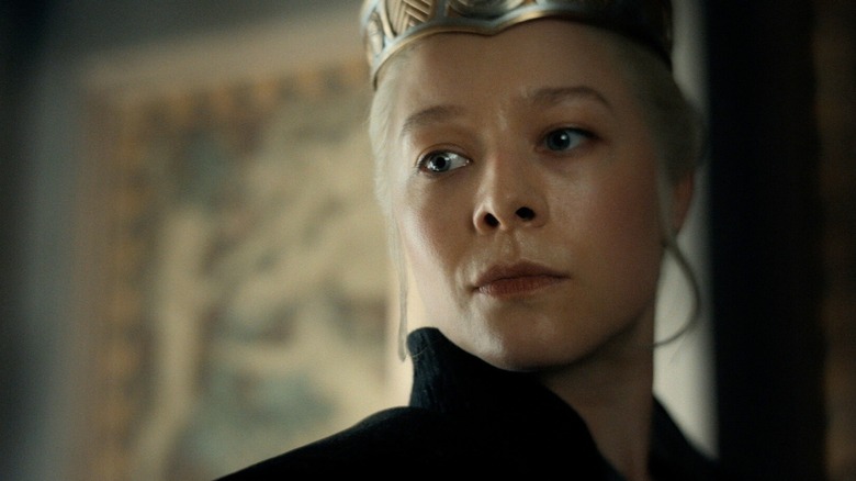 Rhaenyra in her crown, looking down with a stern expression, in House of the Dragon Season 3