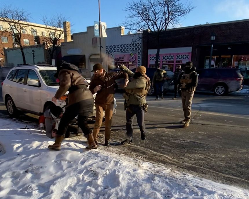 Videos show agents pepper spraying Alex Pretti before wrestling him to the ground. An agent wearing a gray jacket can be seen removing a gun from Pretti just prior to officers fatally shooting him.