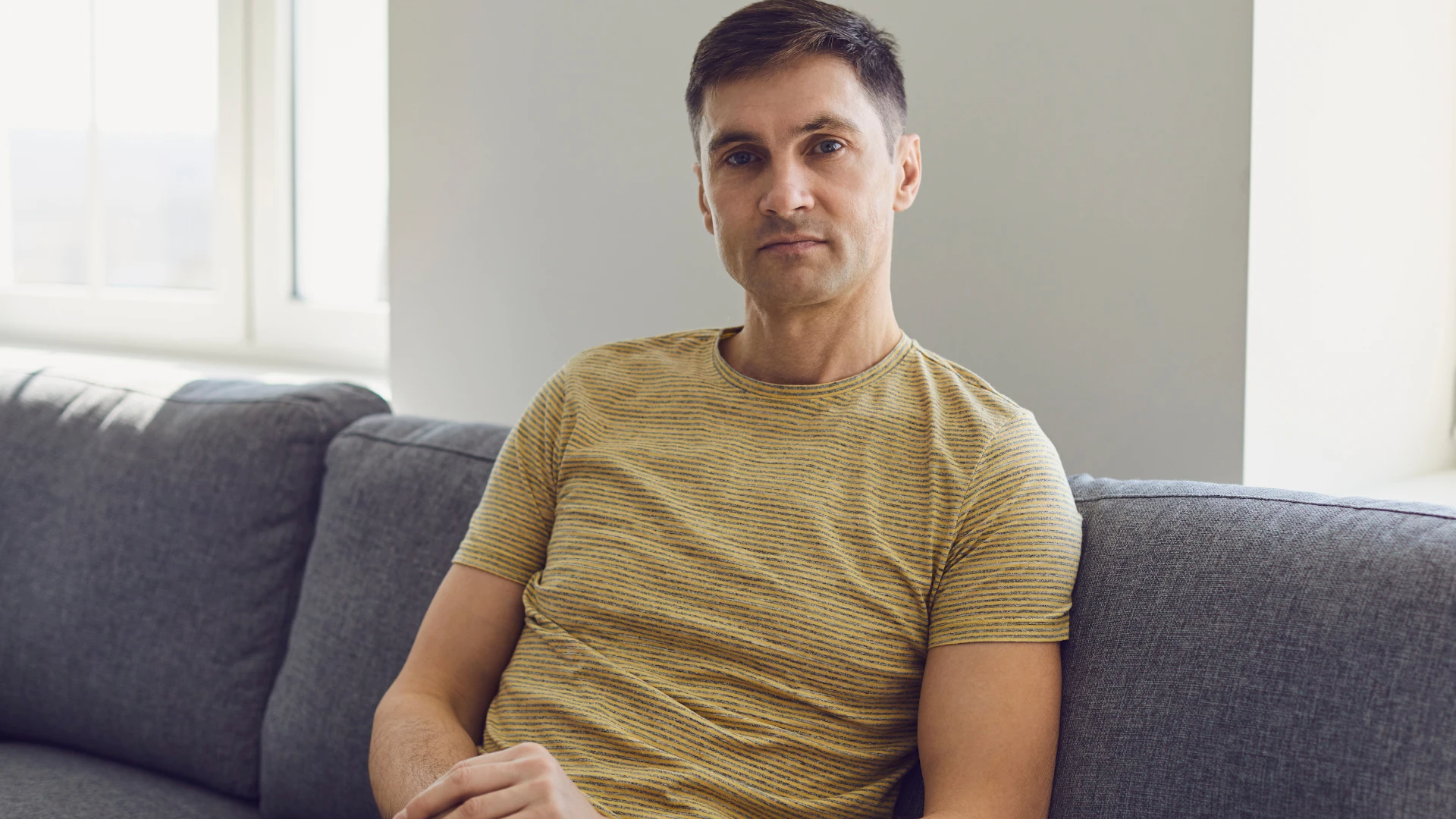 man sitting in a living room with a lack of personality
