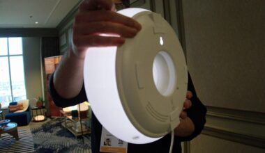 Ikea's new smart lamp held by person in room.