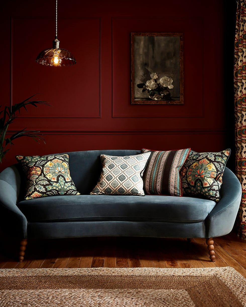 stylish seating area featuring a curved sofa with decorative cushions and ambient lighting