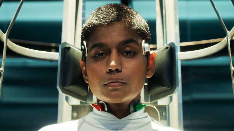 Linnea Berthelsen's Kali Prasad is seen in closeup as she's held on an upright stretcher in Stranger Things