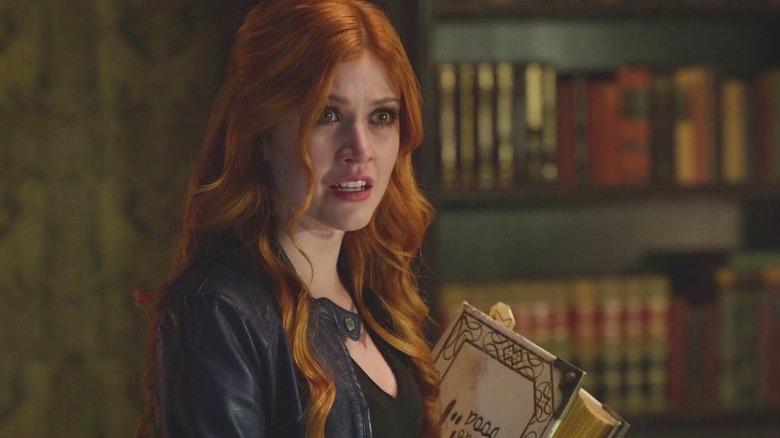 Clary holding book
