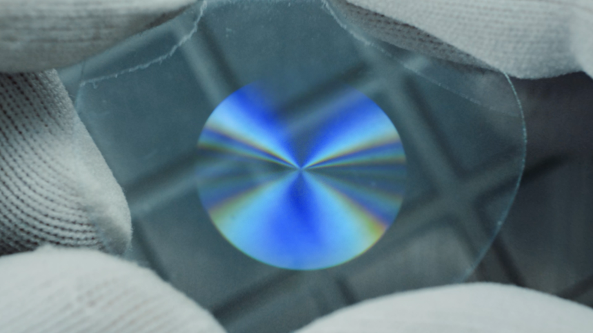 An IXI engineer holding the liquid crystal lens in its active state.