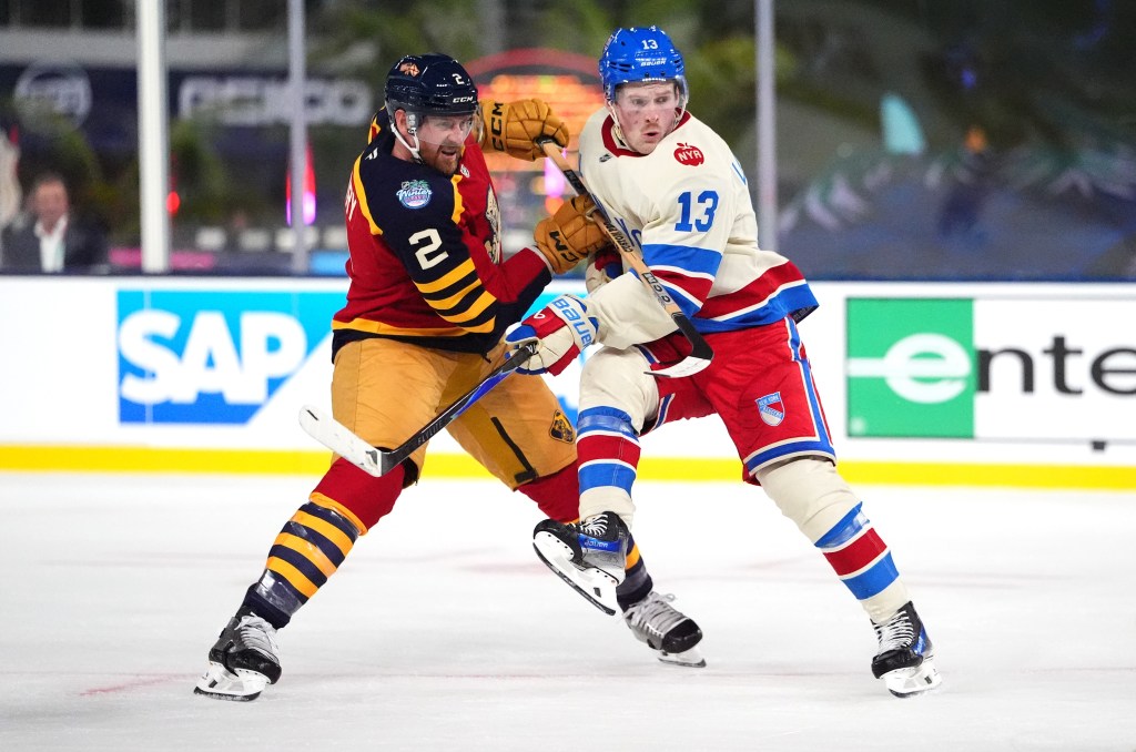 Jeff Petry #2 of the Florida Panthers and Alexis Lafreniere #13 of the New York Rangers vie for position during the second period of the 2026 Discover NHL Winter Classic game between the New York Rangers and the Florida Panthers at loanDepot park on January 02, 2026 in Miami, Florida. 