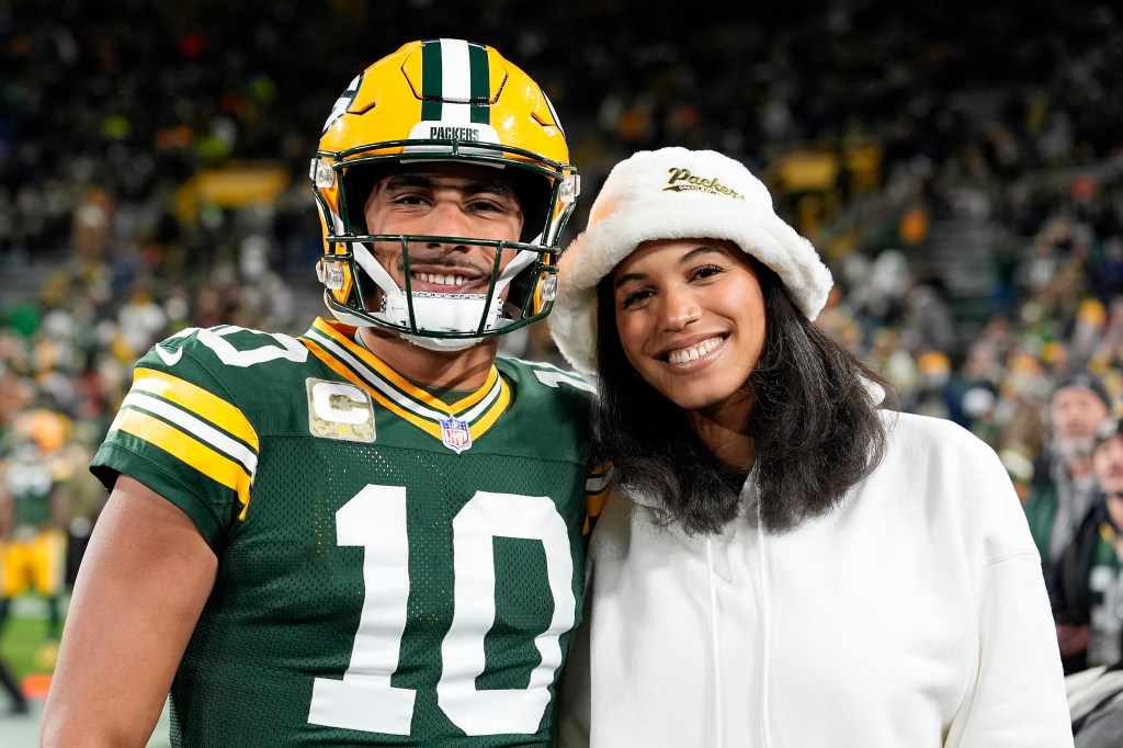 Jordan Love and Ronika Stone posing at Lambeau Field.