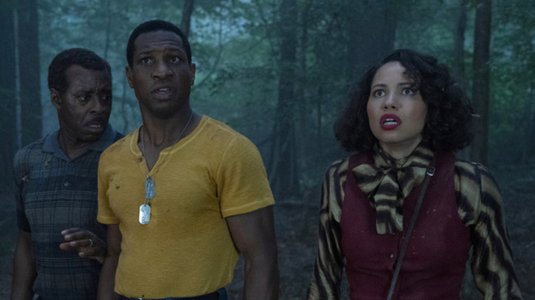 George Freeman (Courtney B. Vance), Atticus Freeman (Jonathan Majors), and Letitia Lewis (Jurnee Smollett) stand bewildered in a forest in Lovecraft Country