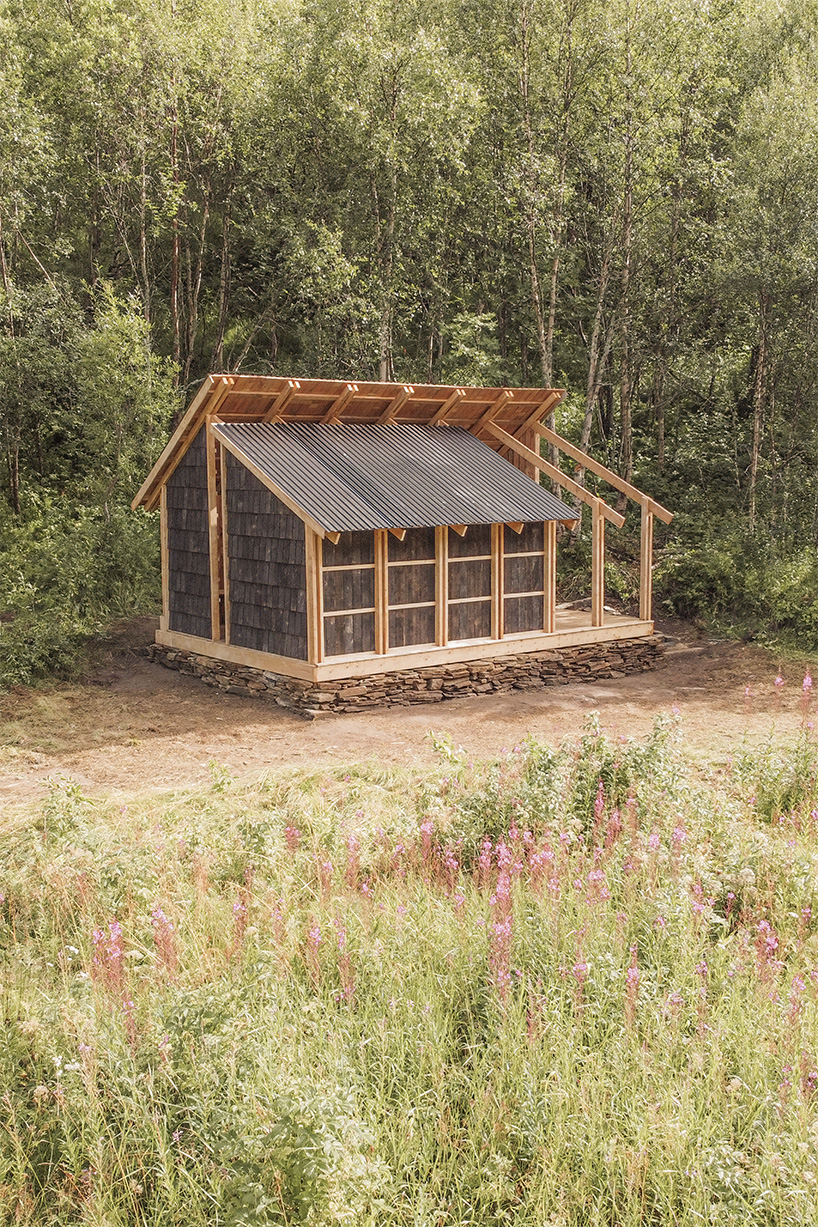 student collective builds fireplace shelter from reclaimed materials in northern norway