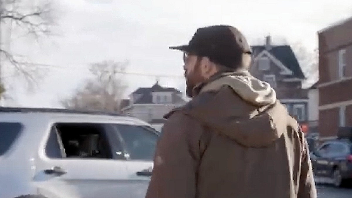 Man with hat and jacket.