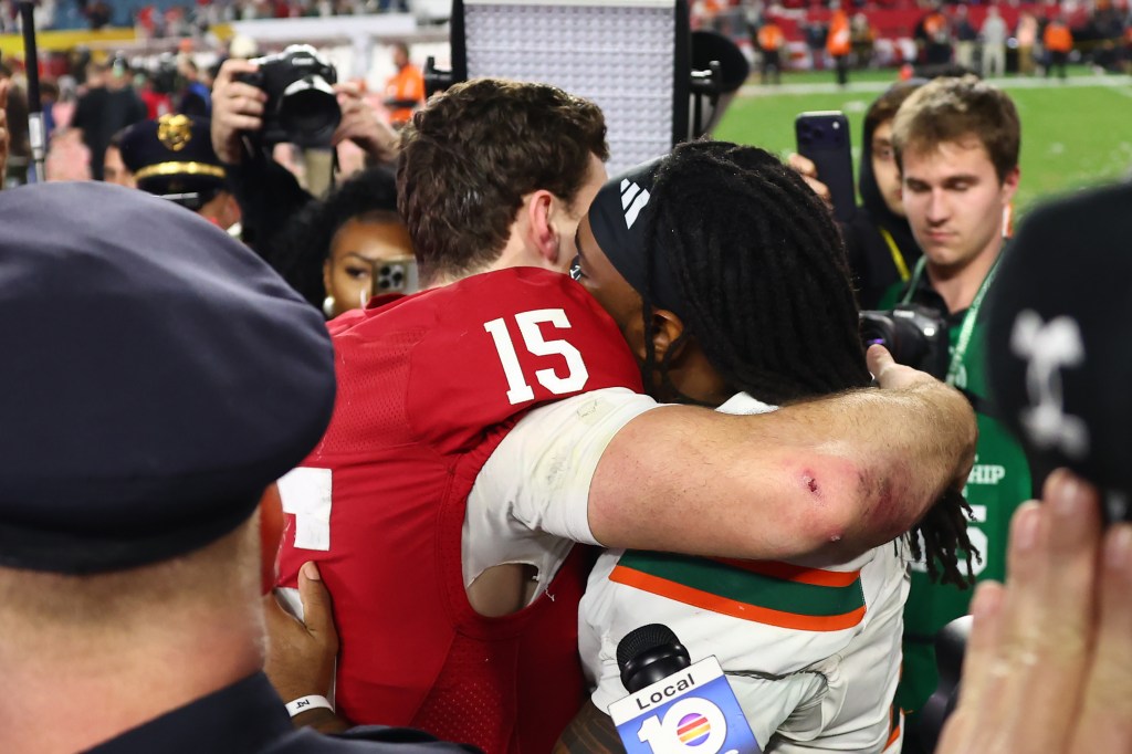 Miami's Mark Fletcher Jr. hugs Indiana's Fernando Mendoza after Indiana won the 2026 College Football Playoff National Championship.