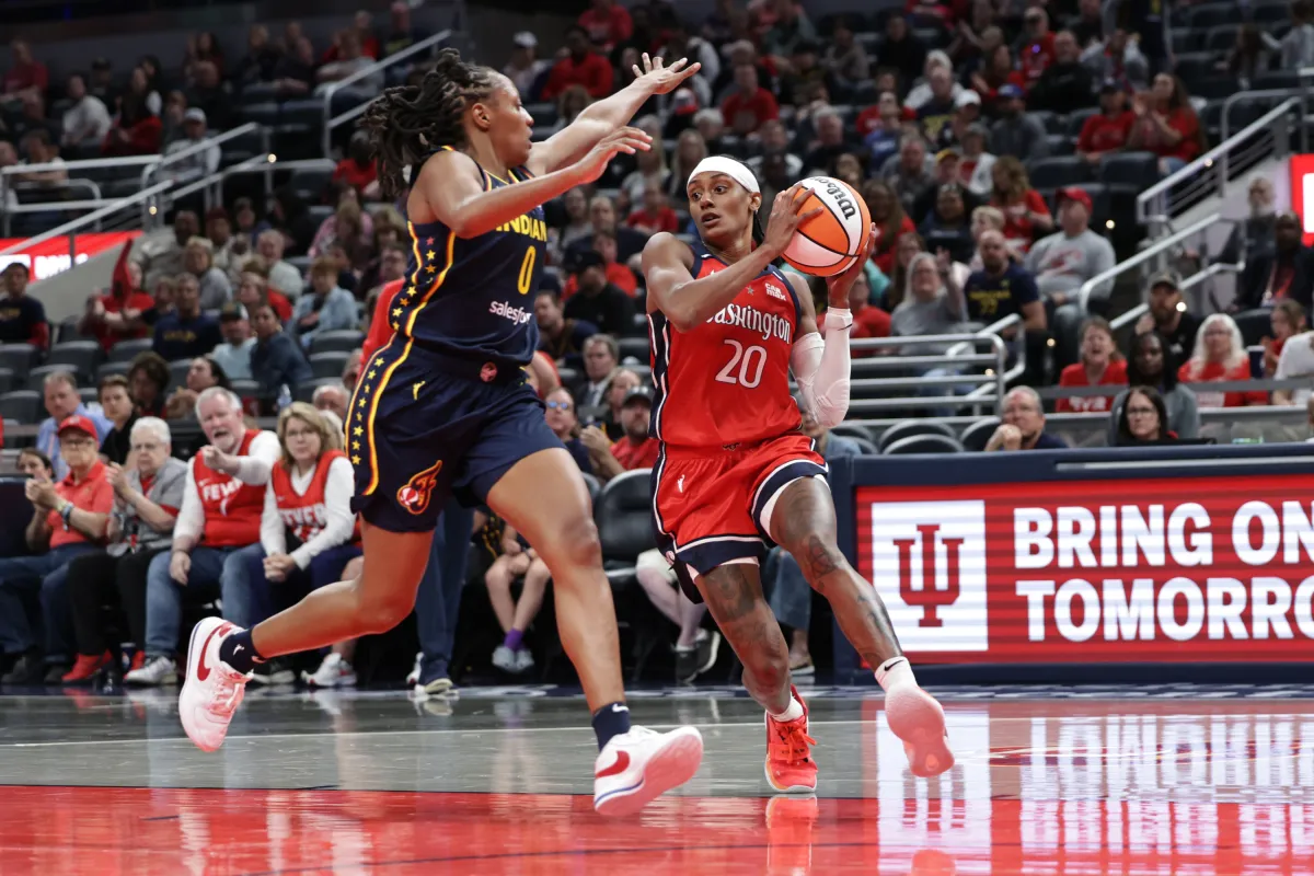NDIANAPOLIS, INDIANA - MAY 3: Brittney Sykes #20 of the Washington Mystics dribbles past Kelsey Mitchell #0 of the Indiana Fever during the first half at Gainbridge Fieldhouse on May 3, 2025 in Indianapolis, Indiana. N