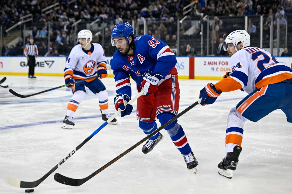 Mika Zibanejad of the New York Rangers is defended by Scott Mayfield of the New York Islanders.