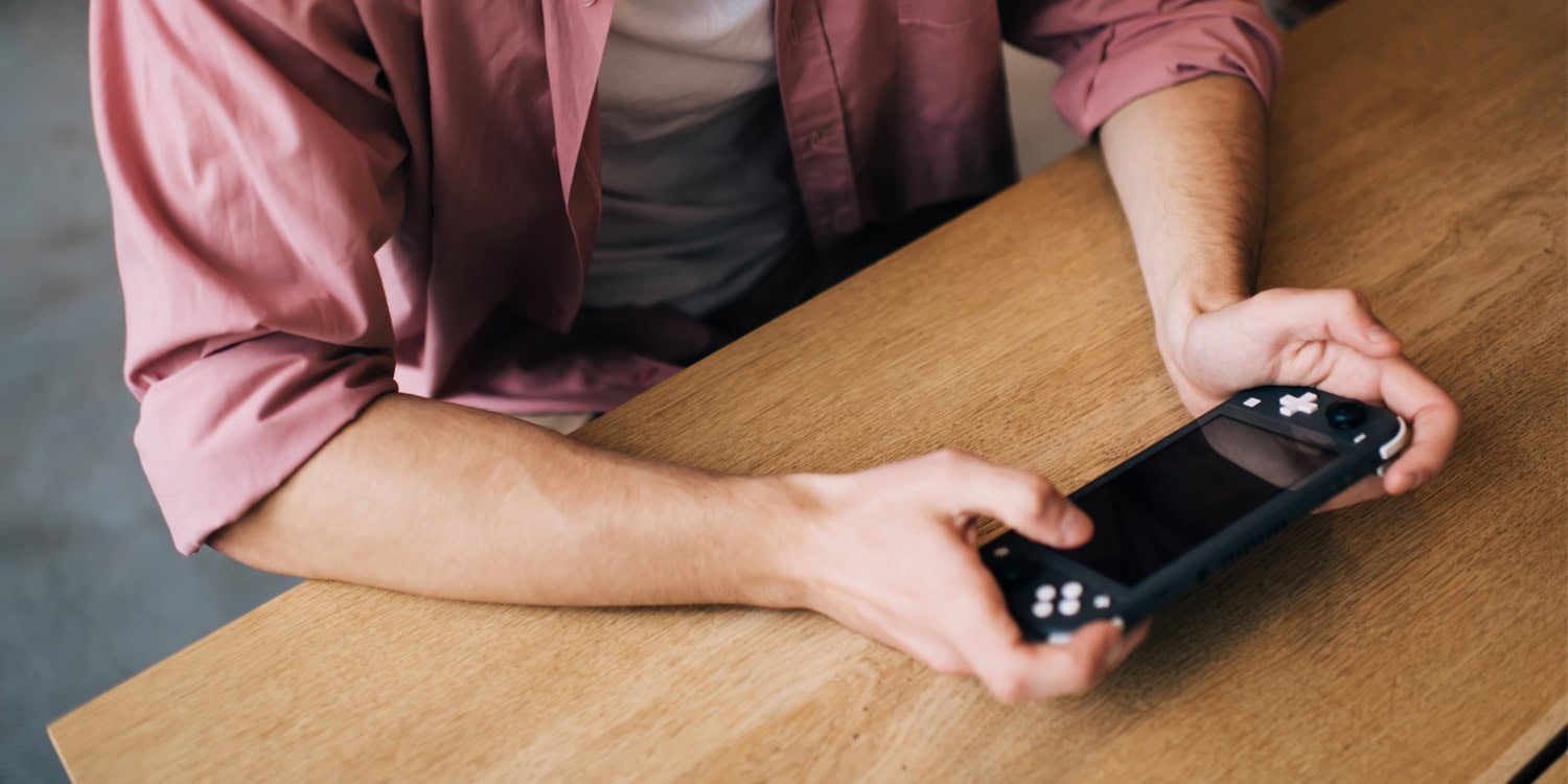 A person playing a mobile game on a smartphone.