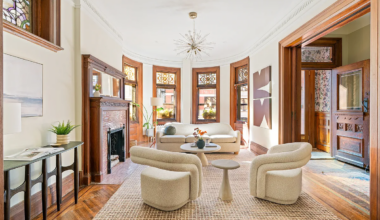 parlor with wood floors, mantel, stained glass