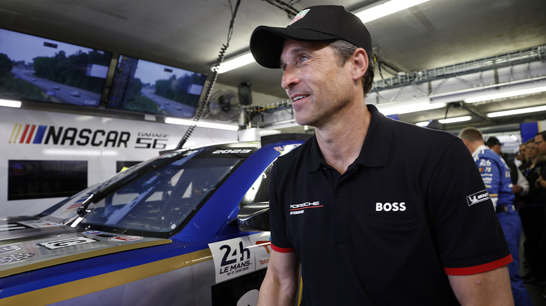 Patrick Dempsey talks with drivers Jenson Button and Mike Rockenfeller of the #24 NASCAR Next Gen Chevrolet ZL1 ahead of the 100th anniversary of the 24 Hours of Le Mans at the Circuit de la Sarthe June 10, 2023 in Le Mans, France.