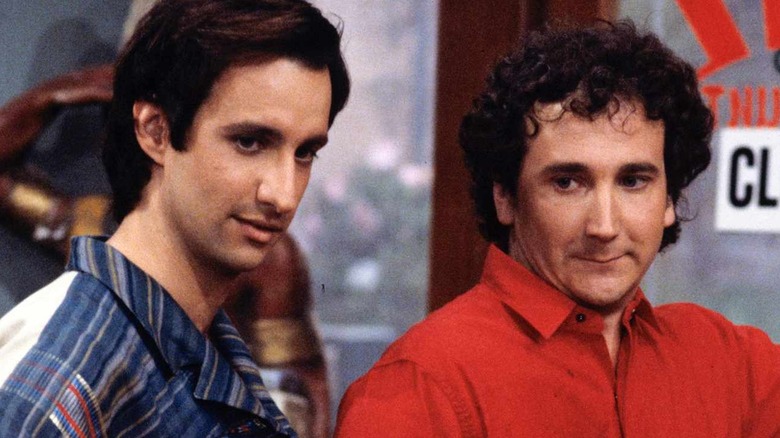 Bronson Pinchot as Balki Bartokomous stands next to Mark Linn-Baker as Larry Appleton in Perfect Strangers