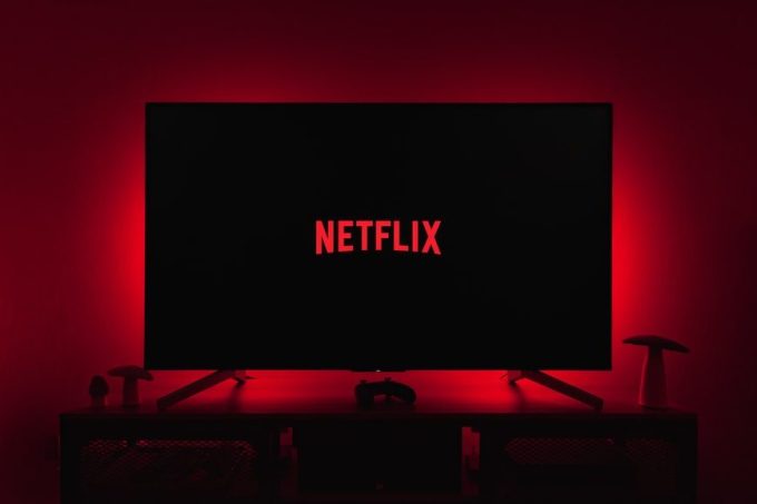 netflix logo on black screen backlit by red glow