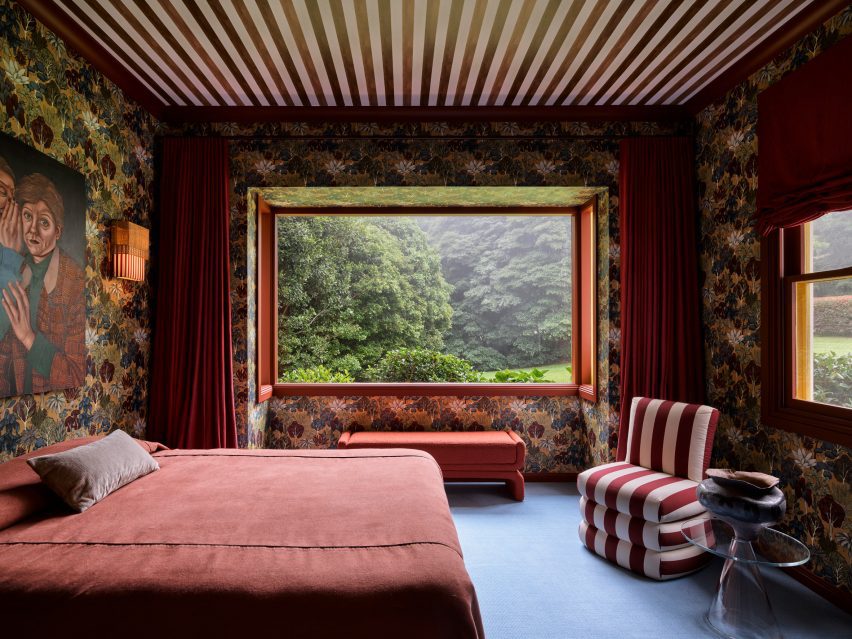 Bedroom with striped ceiling and patterned red wallpaper