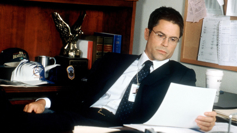 Sam Seaborn looks at paper at a desk on The West Wing (1999-2006)
