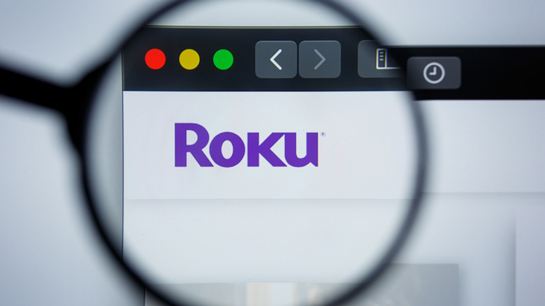 A magnifying glass is pictured over the Roku logo.