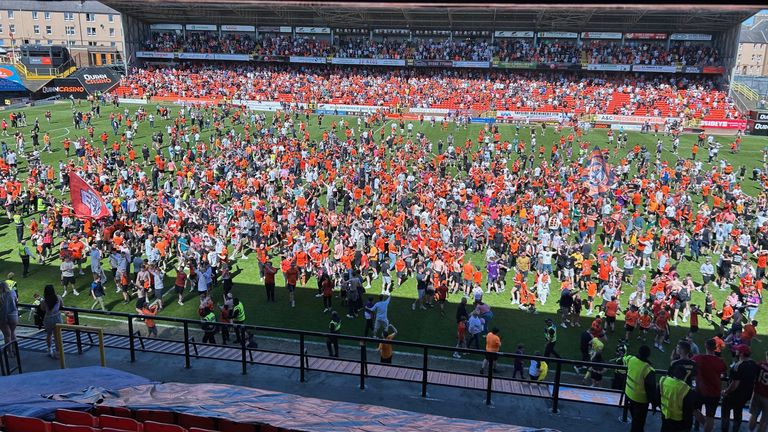 Fans on the pitch after Dundee United's victory at Tannadice. Pic: PA
