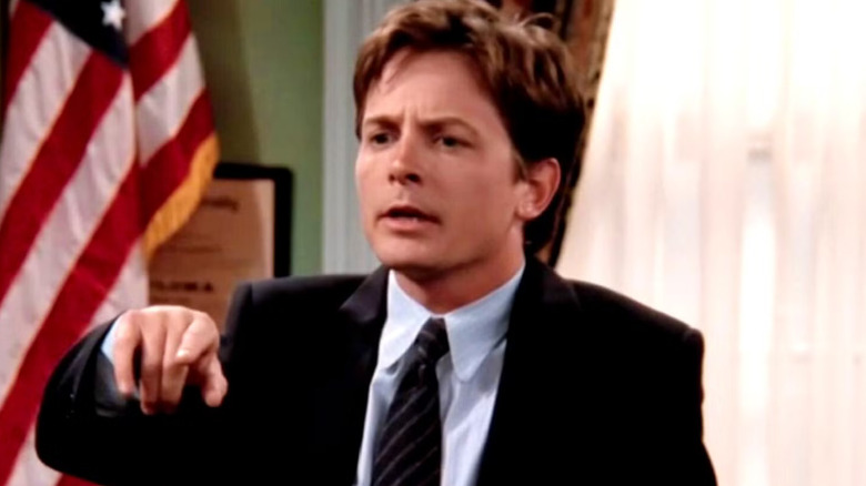 Michael J. Fox as Mike Flaherty points in Spin City