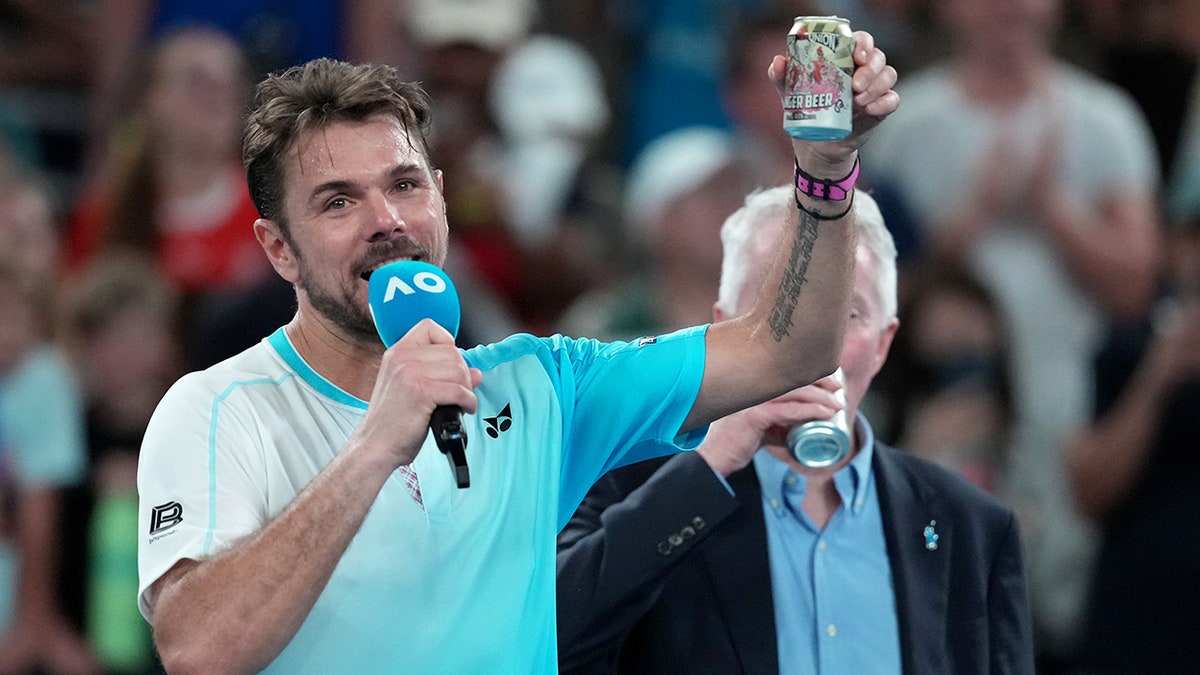 Stan Wawrinka holds beer