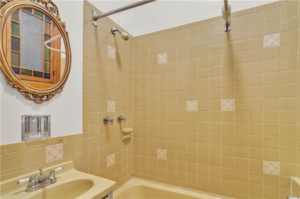 bathroom with yellow wall tiles and fixtures