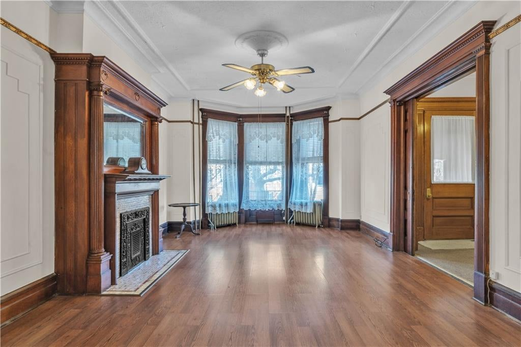 parlor with mantel with mirror