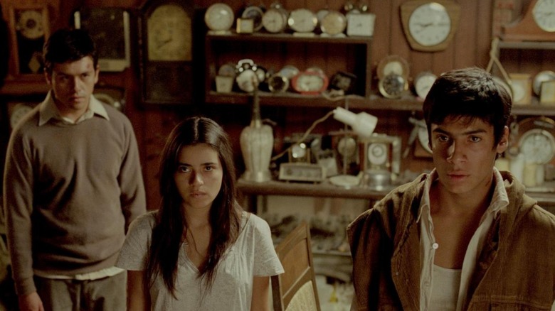 Alfredo, Julian, and Sabina gather around in We Are What We Are