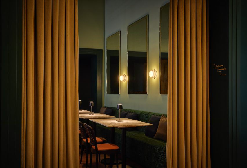 Antique mirrors and banquette seating in a bistro-style dining space