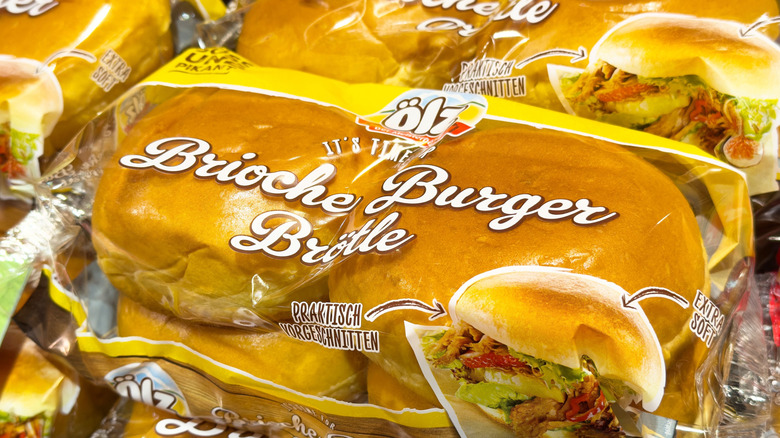 Packaged brioche burger buns display on store shelf.