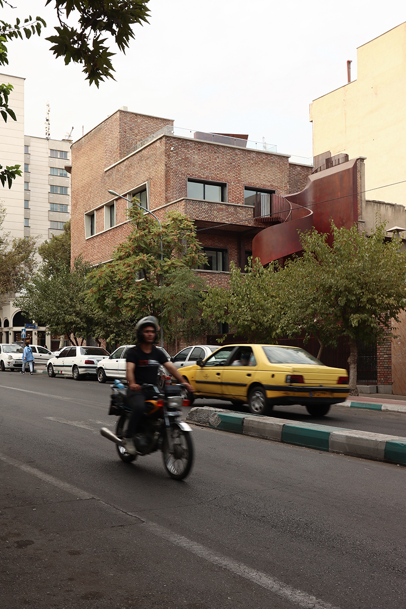 sculptural steel staircase and wall breathes new life into iranian poet’s 1970s home