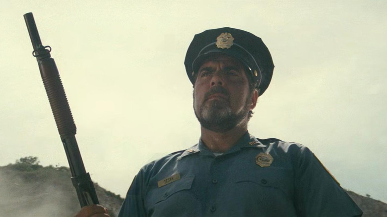 Testa staring with his gun in 